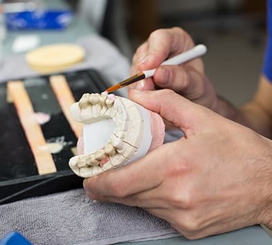 Lab technician creating dental restoration