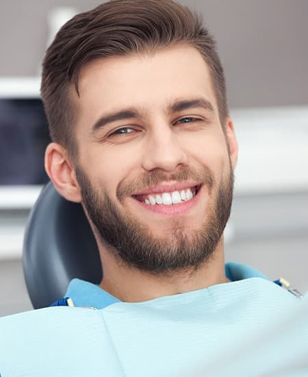 Man in dental chair with healthy smile