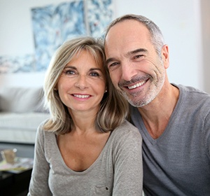 An older couple with dental implants in Alexandria smiling.