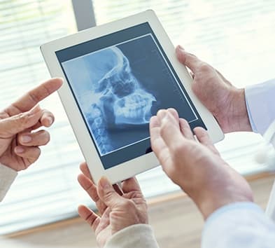 X-ray of full jaw and skull on tablet computer