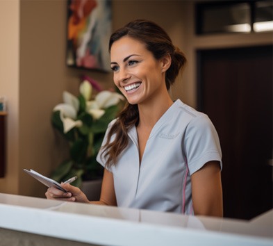 Dental receptionist helping patient