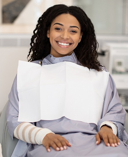 Smiling young woman in dental treatment chair