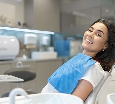 Smiling patient reclining in treatment chair