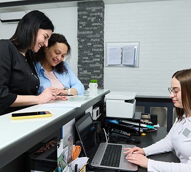 Patients standing at dental office front desk